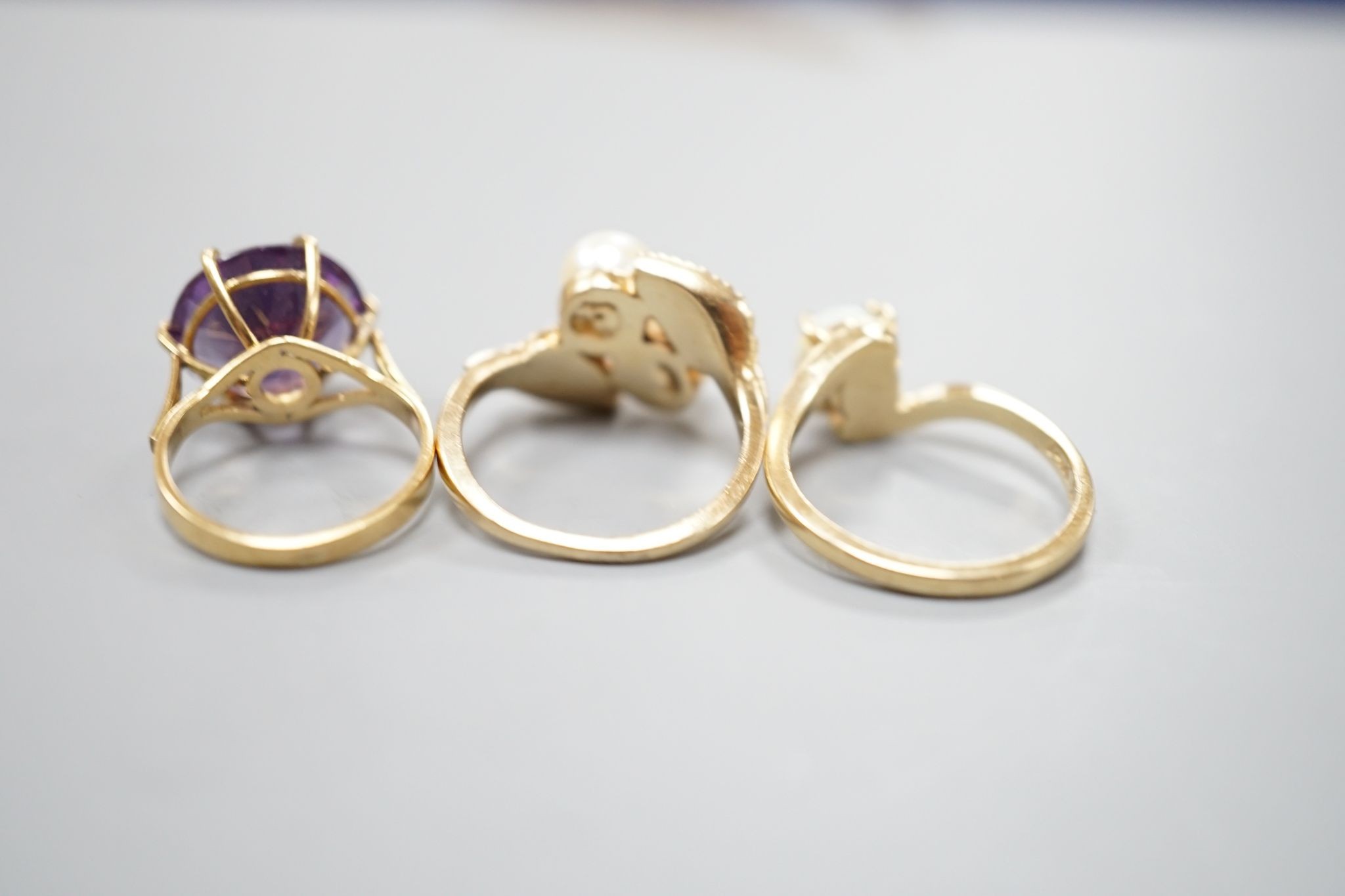 Three assorted modern 14k and gem set dress rings, including white opal, size L, gross 10.3 grams